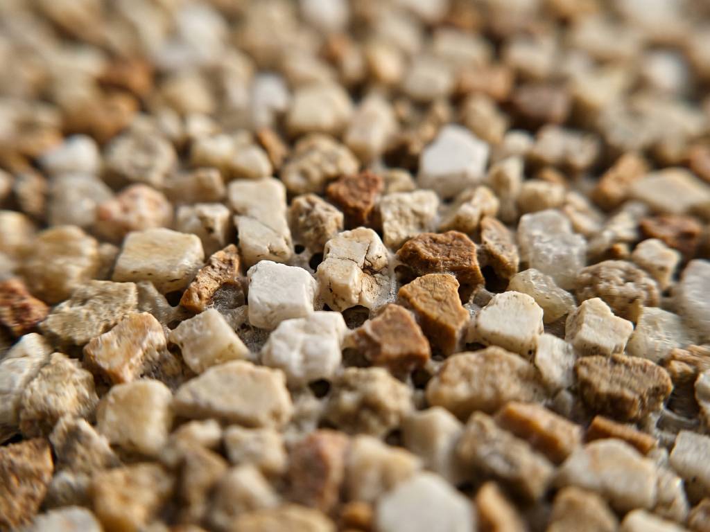 Macro close-up of resin stone surface showing Spanish marble aggregate texture